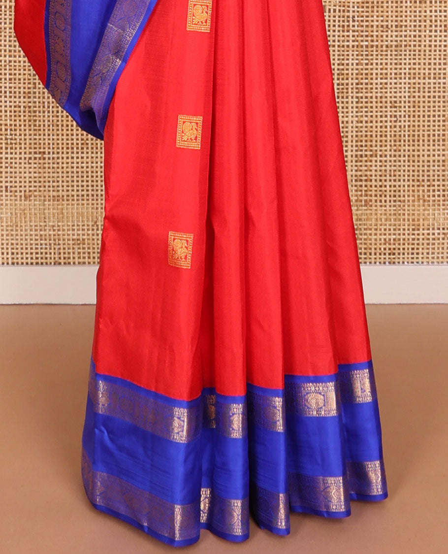 Red zari buttas Kanchipuram silk saree, contrast rettai pettu border of rekku, muthu, diamond, and annam chakram designs, and intricate pallu