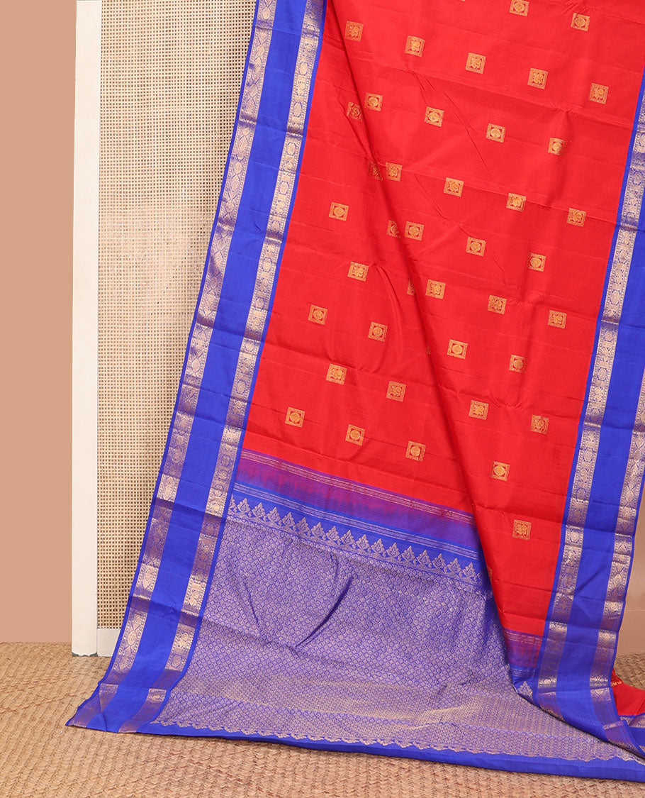 Red zari buttas Kanchipuram silk saree, contrast rettai pettu border of rekku, muthu, diamond, and annam chakram designs, and intricate pallu
