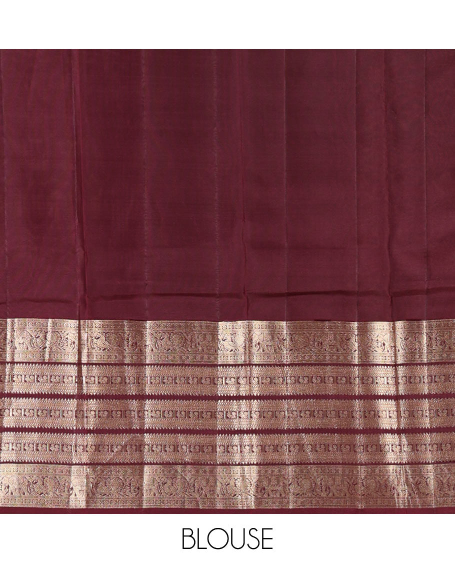 Emerald green striped and annam chakram buttas silk saree, contrast varisai pettu border of rekku, mayil and yaanai designs, and zari rich intricate pallu