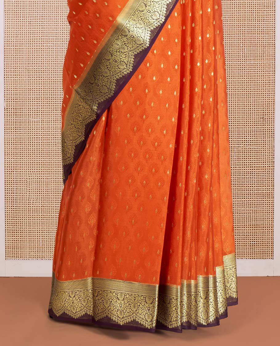 Orange Mysore Silk Saree Subtly Sparkled with Embossed Weave and Zari Buttas All Over Its Body, Complemented by a Contrast Zari Border of Scallop Designs, a Gleaming Pallu of Floral Jaal Design, and a Contrast Blouse
