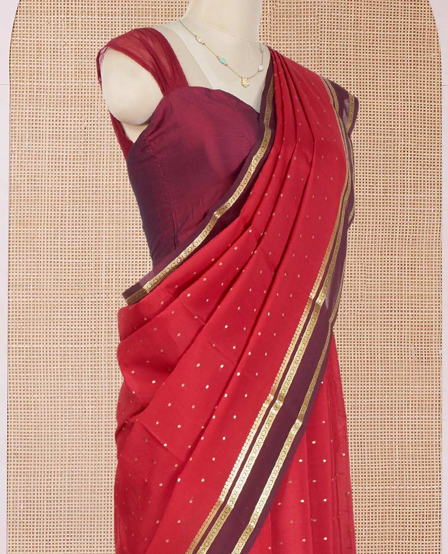 Apple Red Mysore Silk Saree Adorned with Small-Sized Buttas All Over Its Body, Complemented by a Contrast Rettai Pettu Border of Traditional Zari Designs, a Simply Sparkled Pallu of Zari Stripes, and a Contrast Blouse