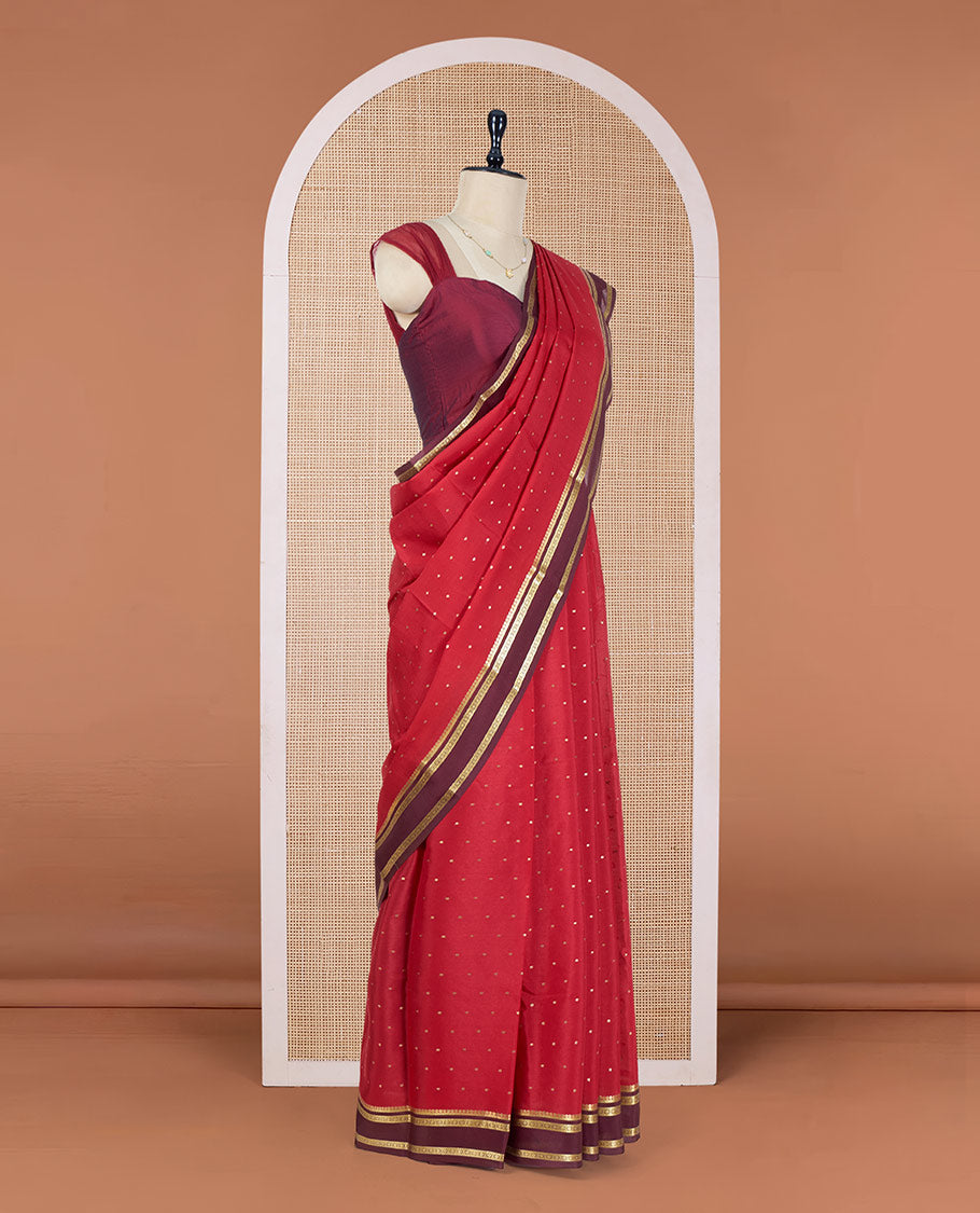 Apple Red Mysore Silk Saree Adorned with Small-Sized Buttas All Over Its Body, Complemented by a Contrast Rettai Pettu Border of Traditional Zari Designs, a Simply Sparkled Pallu of Zari Stripes, and a Contrast Blouse