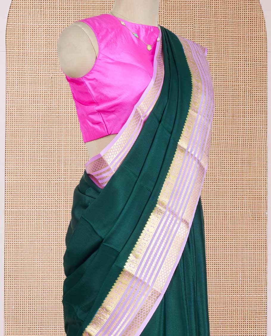 Green Plain Mysore Silk Saree, Complemented by a Contrast Varisai Pettu Border of Traditional Zari Designs, a Subtly Sparkled Pallu of Zari Stripes, and a Contrast Blouse