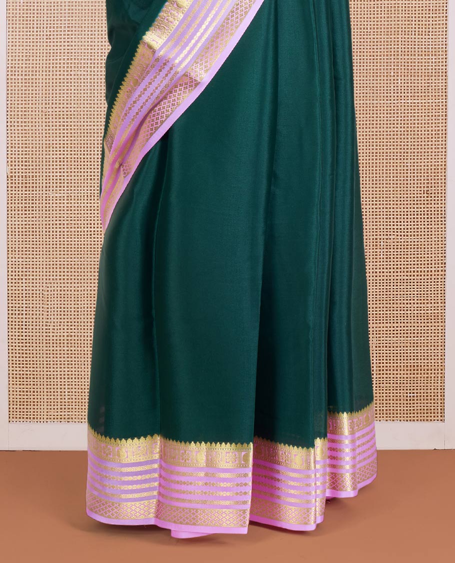 Green Plain Mysore Silk Saree, Complemented by a Contrast Varisai Pettu Border of Traditional Zari Designs, a Subtly Sparkled Pallu of Zari Stripes, and a Contrast Blouse