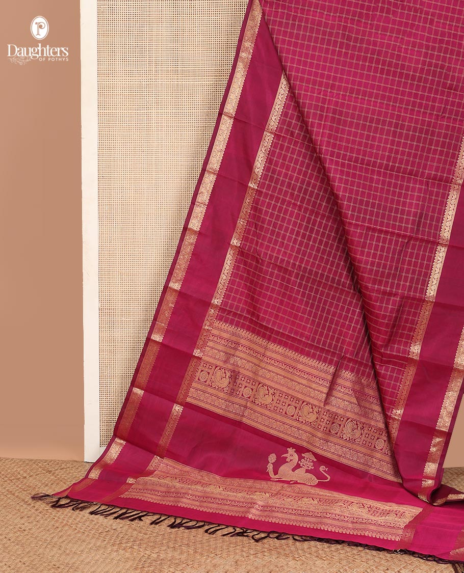 Red checked Kanchipuram silk saree, rettai pettu border of rekku, and jada nagam, and pallu of manga mokku, annam chakram, and Navagunjara designs
