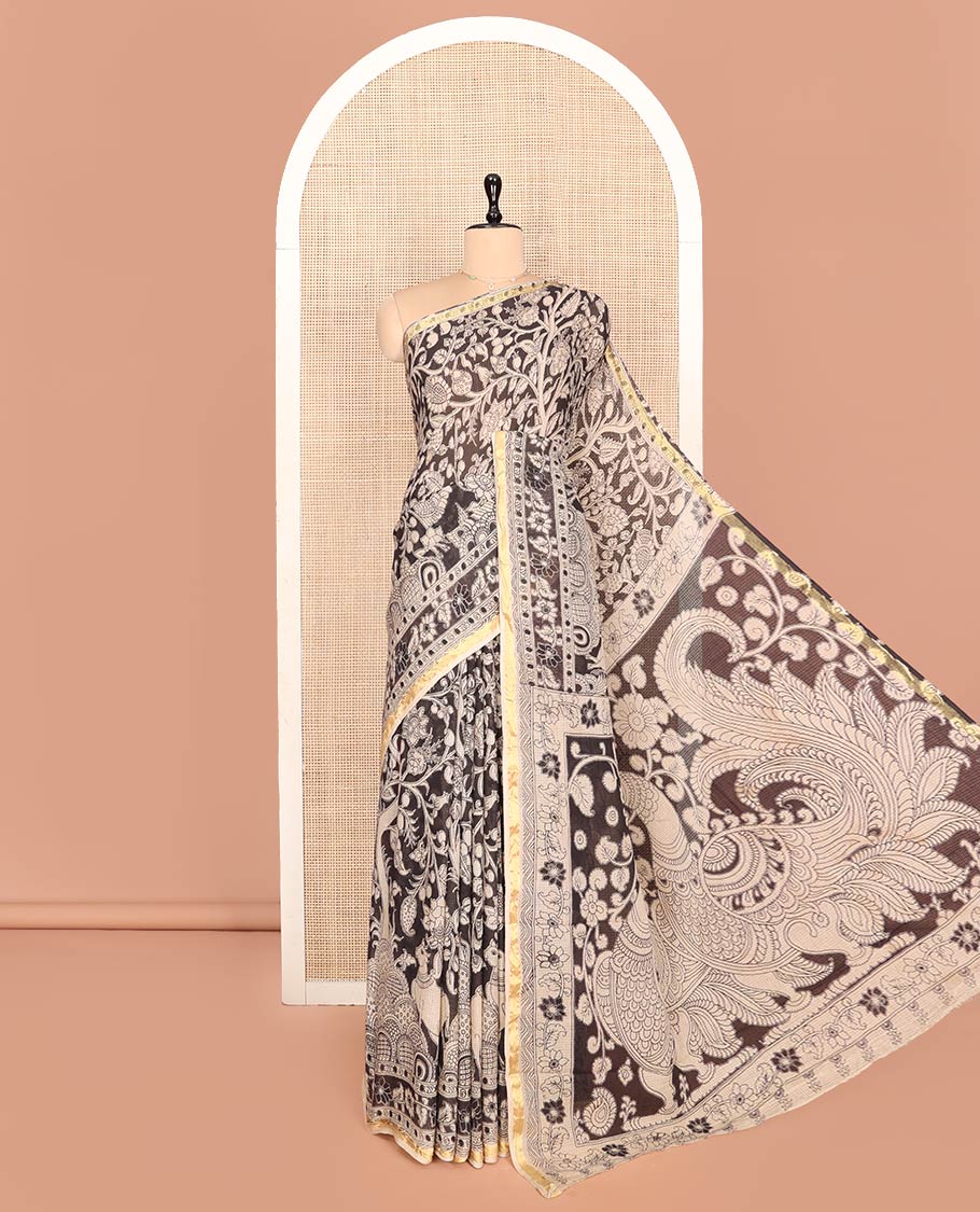Black Machine-Printed Kalamkari Cotton Saree Features Floral Vine and Pichwai Cow, a Piping Border, Kalamkari Peacock Pallu, and a Matching Blouse