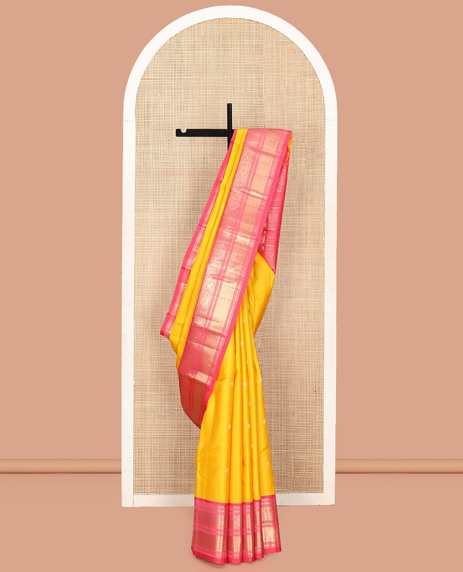 Mango Yellow Vasundhara Silk Saree, Subtly Sparkled with Sparse Stripes and Zari Buttas, Complemented by a Contrast Border of Thilakam, Banaras, Muthu, and Round Mayil Designs, Pallu Steeped with Traditional Designs, and Paired with a Contrast Blouse