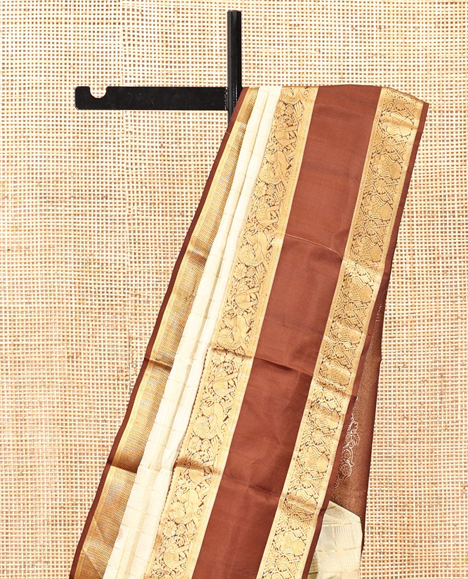 Pale Green Vasundhara Silk Saree, Enriched with Zari Buttas Enclosed Checks All Over Its Body, Complemented by a Contrast Rettai Pettu Border of Muthu, Banaras, and Iruthalai Pakshi Designs, a Grand Pallu, and Paired with a Contrast Blouse