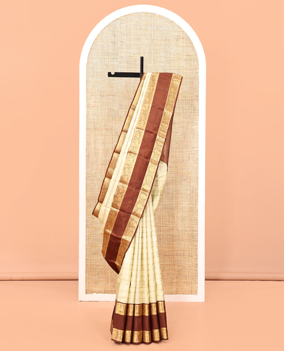 Pale Green Vasundhara Silk Saree, Enriched with Zari Buttas Enclosed Checks All Over Its Body, Complemented by a Contrast Rettai Pettu Border of Muthu, Banaras, and Iruthalai Pakshi Designs, a Grand Pallu, and Paired with a Contrast Blouse