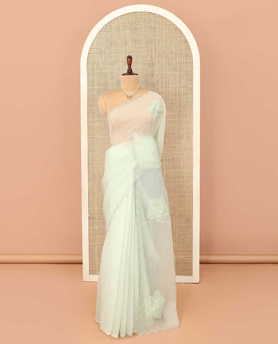 Cream five-petal flowers embroidered saree with scallop stone work border