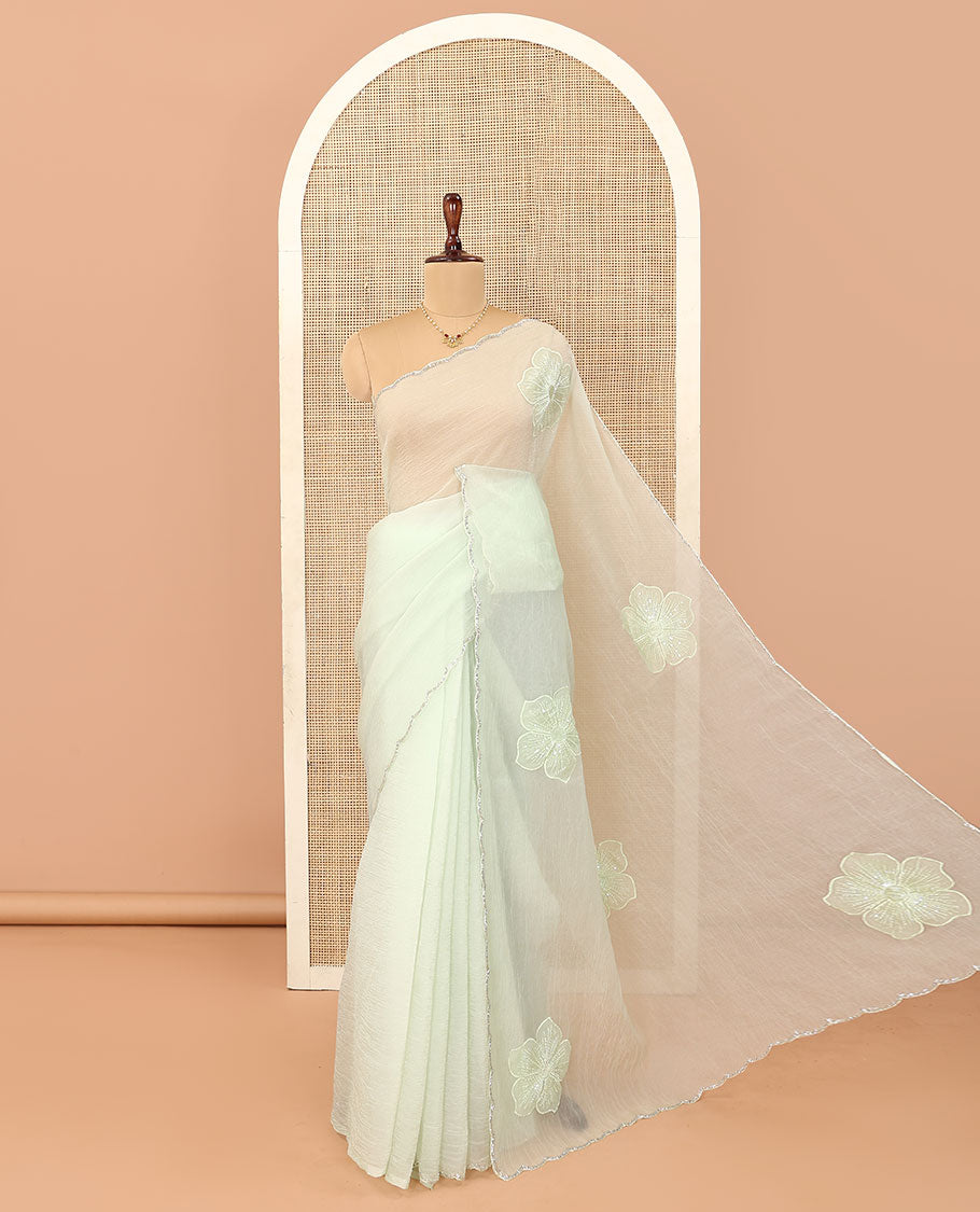 Cream five-petal flowers embroidered saree with scallop stone work border