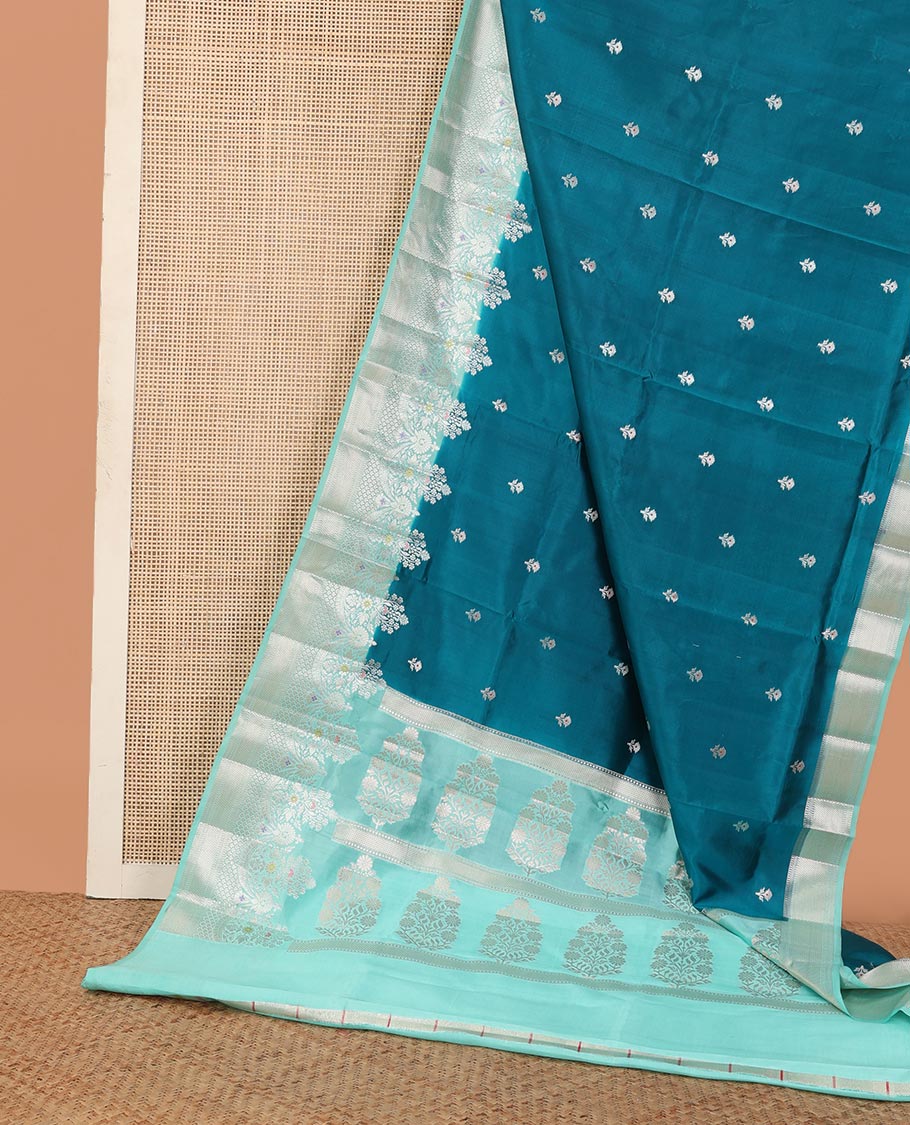 Blue floral buttas raw mango silk saree, contrast traditional zari design meenakari border, and floral bouquet pallu
