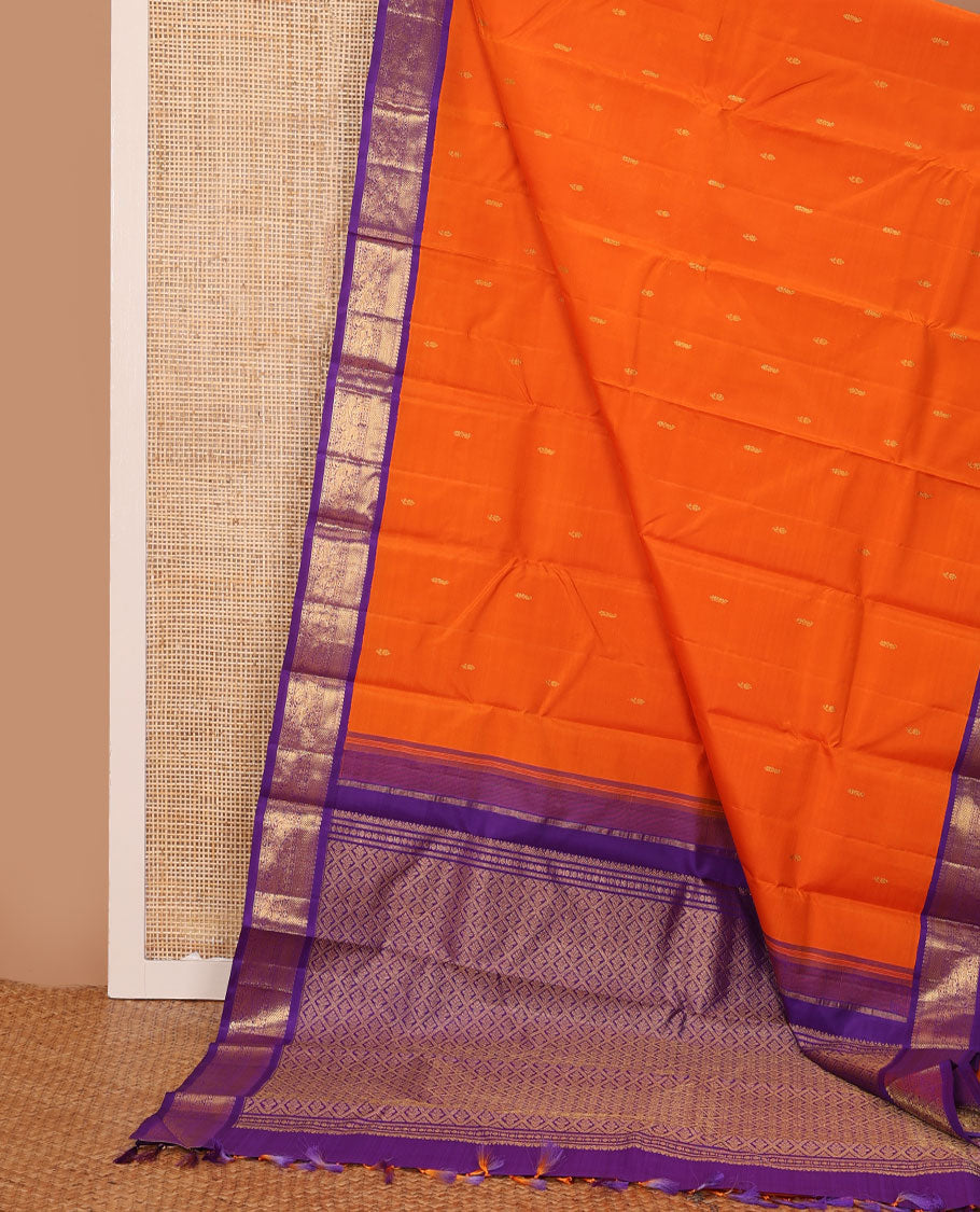 Orange zari buttas Kanchipuram silk saree, contrast korvai border of manga mokku, muthu, diamond, lavangam, and mayil design, and jaal pallu