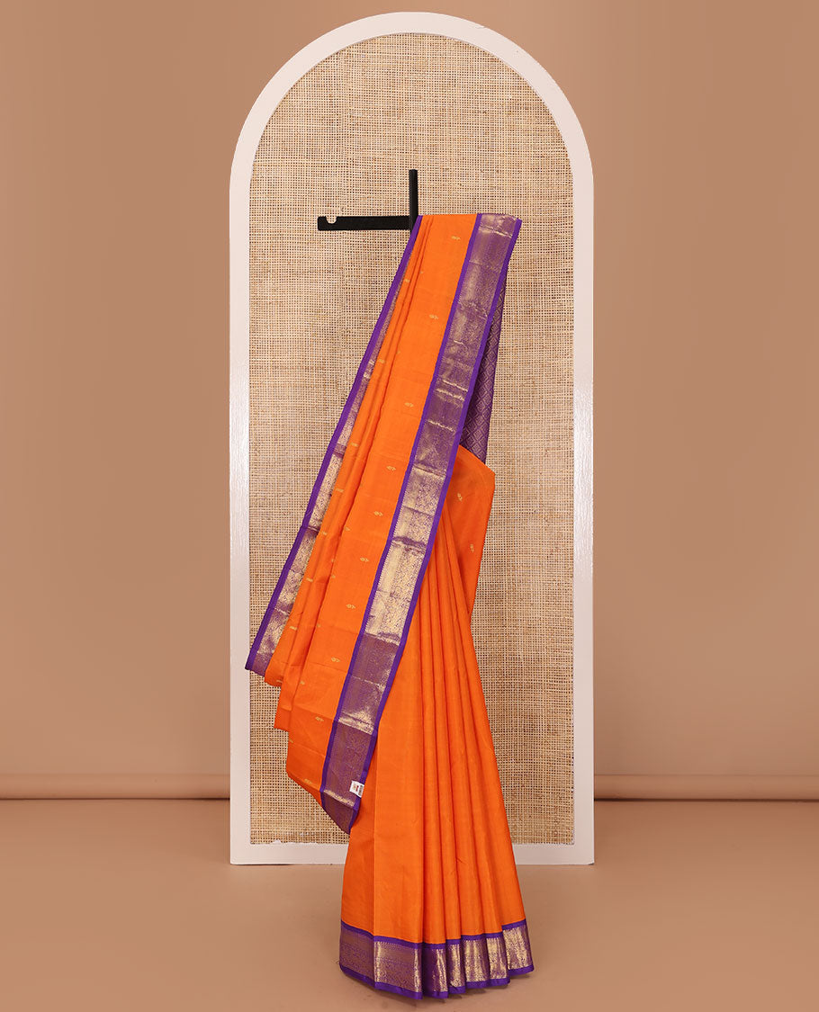 Orange zari buttas Kanchipuram silk saree, contrast korvai border of manga mokku, muthu, diamond, lavangam, and mayil design, and jaal pallu