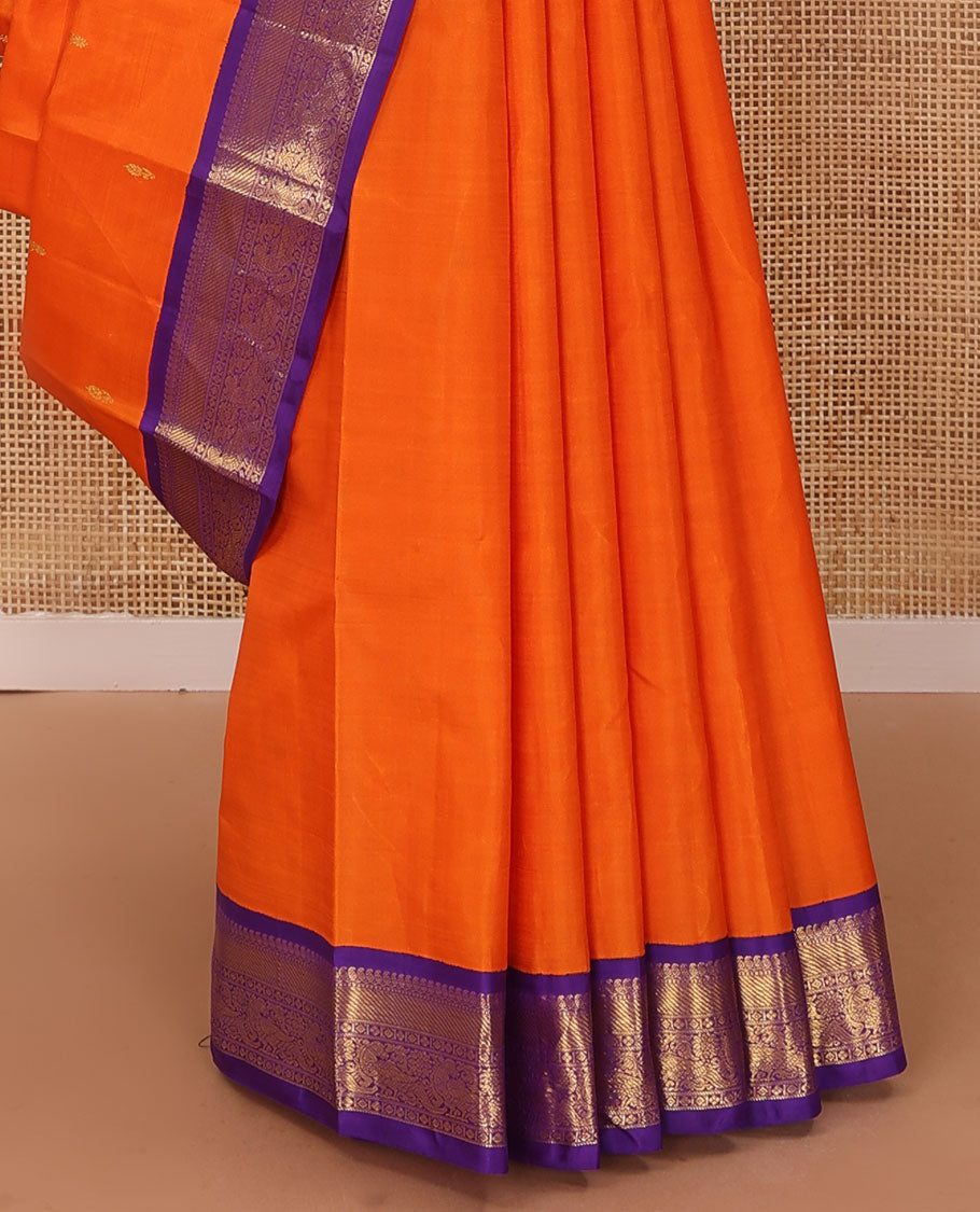Orange zari buttas Kanchipuram silk saree, contrast korvai border of manga mokku, muthu, diamond, lavangam, and mayil design, and jaal pallu
