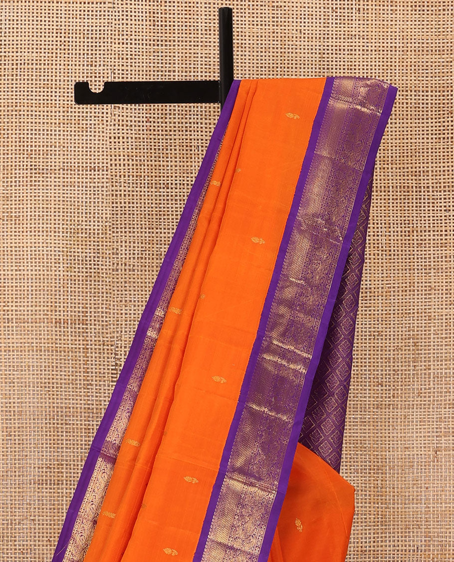 Orange zari buttas Kanchipuram silk saree, contrast korvai border of manga mokku, muthu, diamond, lavangam, and mayil design, and jaal pallu