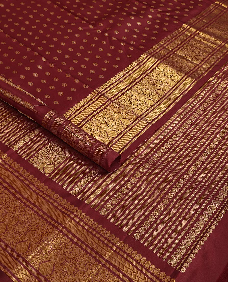 Maroon chakram buttas Kanchipuram silk saree, zari border of banaras,vanki & iru thalai pakshi & pallu of kathir,kamalam,mayil,yaanai,manga & iruthalai pakshi