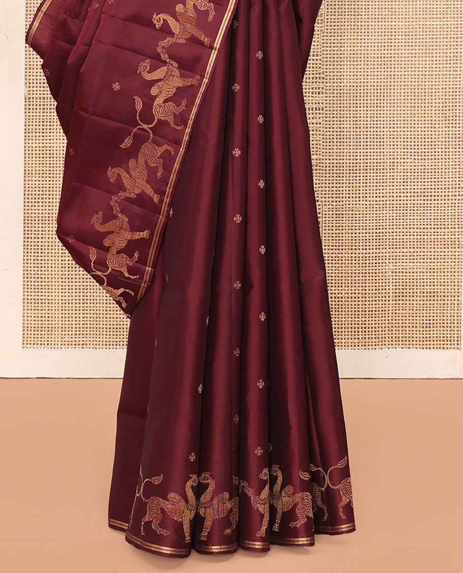 Maroon Mayuri Soft Silk Saree, Adorned with Zari Buttas All Over Its Body, Highlighted by Zari Border of Navagunjara Motifs, Pallu Steeped with Navagunjara Designs, and Paired with a Matching Blouse