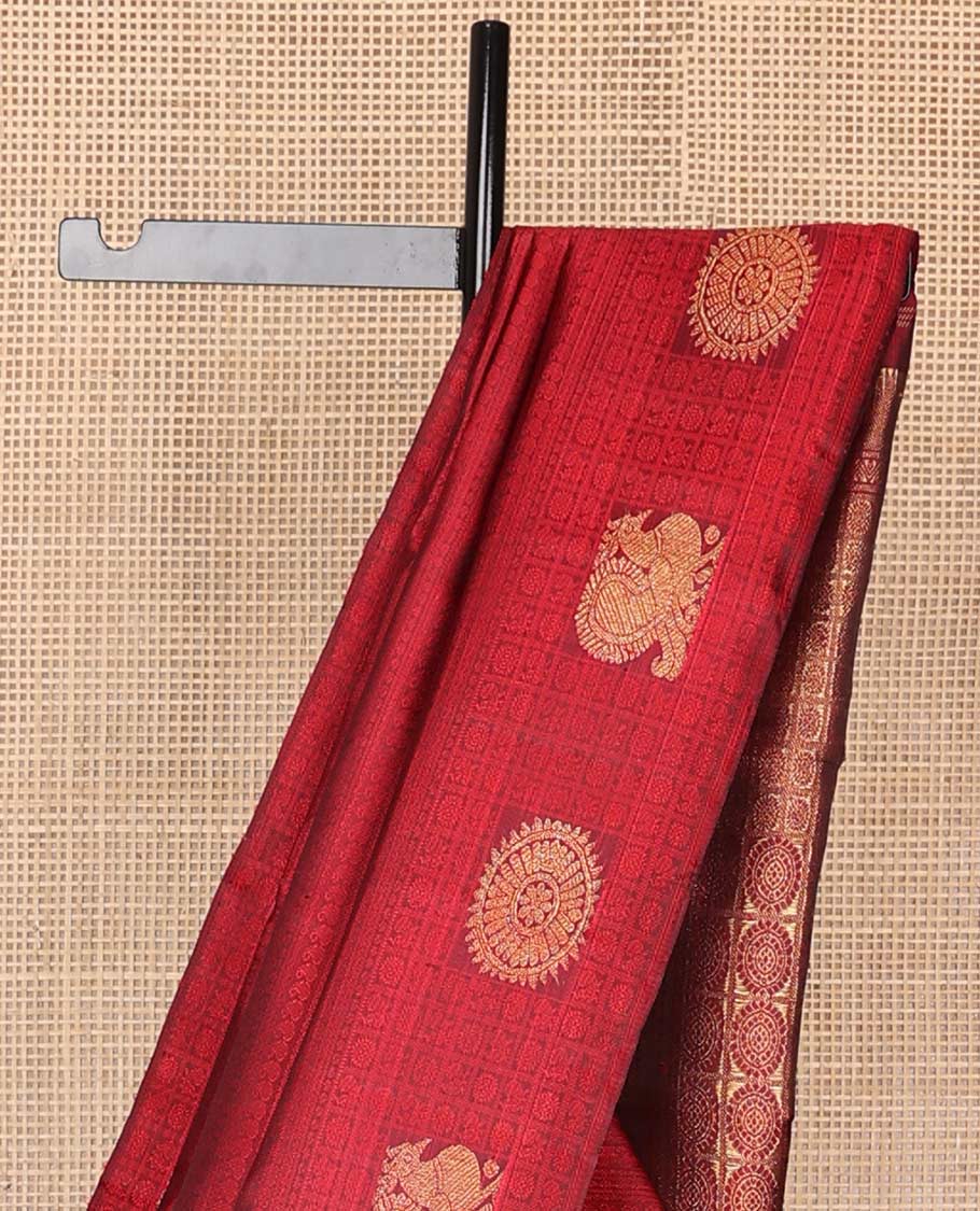 Red intricate embossed design silk saree with self border of poo chkaram, mayil design & checked floral design pallu