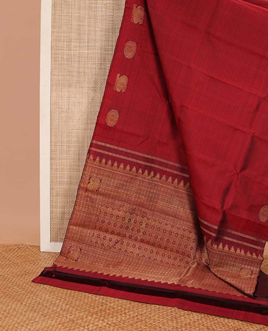 Red intricate embossed design silk saree with self border of poo chkaram, mayil design & checked floral design pallu