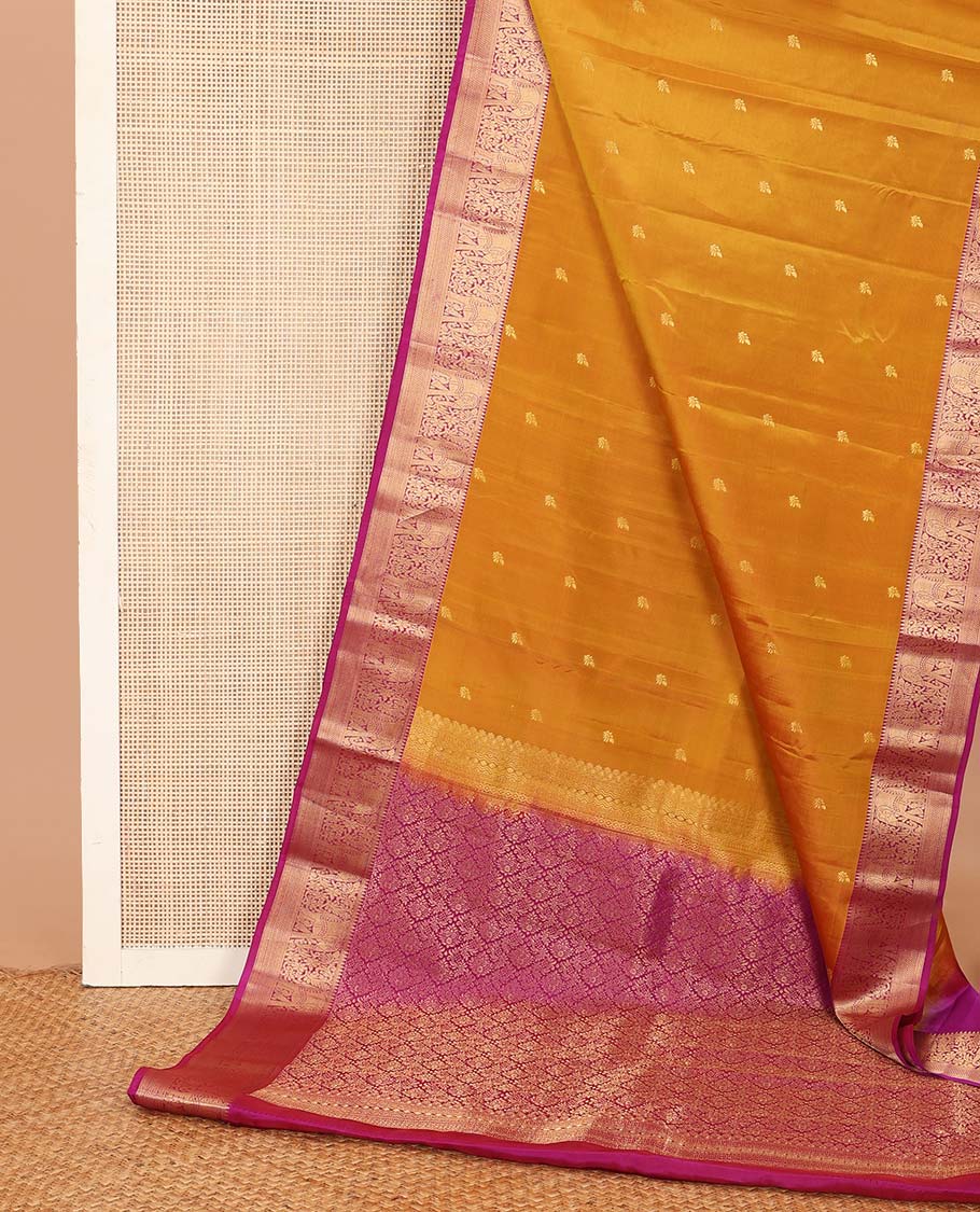 Orange zari buttas Vasundhara silk mix saree, contrast border of thilakam mokku, yaanai, kathir, and zari designs, and intricate pallu