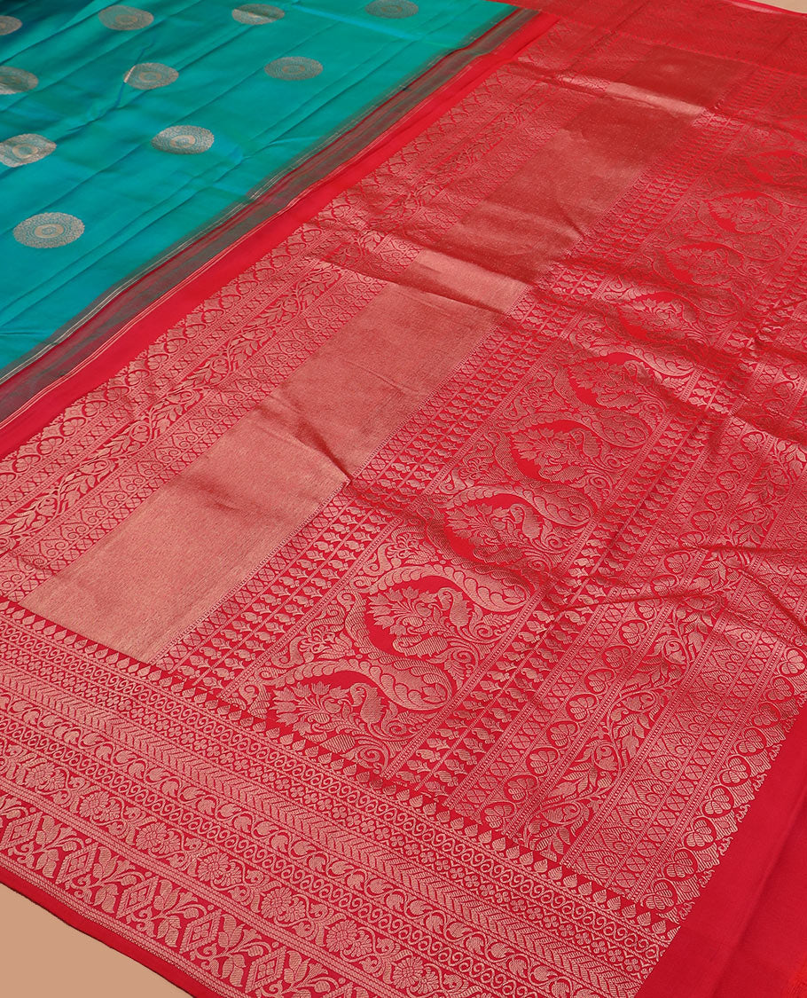 Peacock blue charkam buttas Vasundhara silk saree, contrast border of thilakam mokku, neli, kamalam, kathir, floral, and diamond designs, and Mughal floral woven pallu
