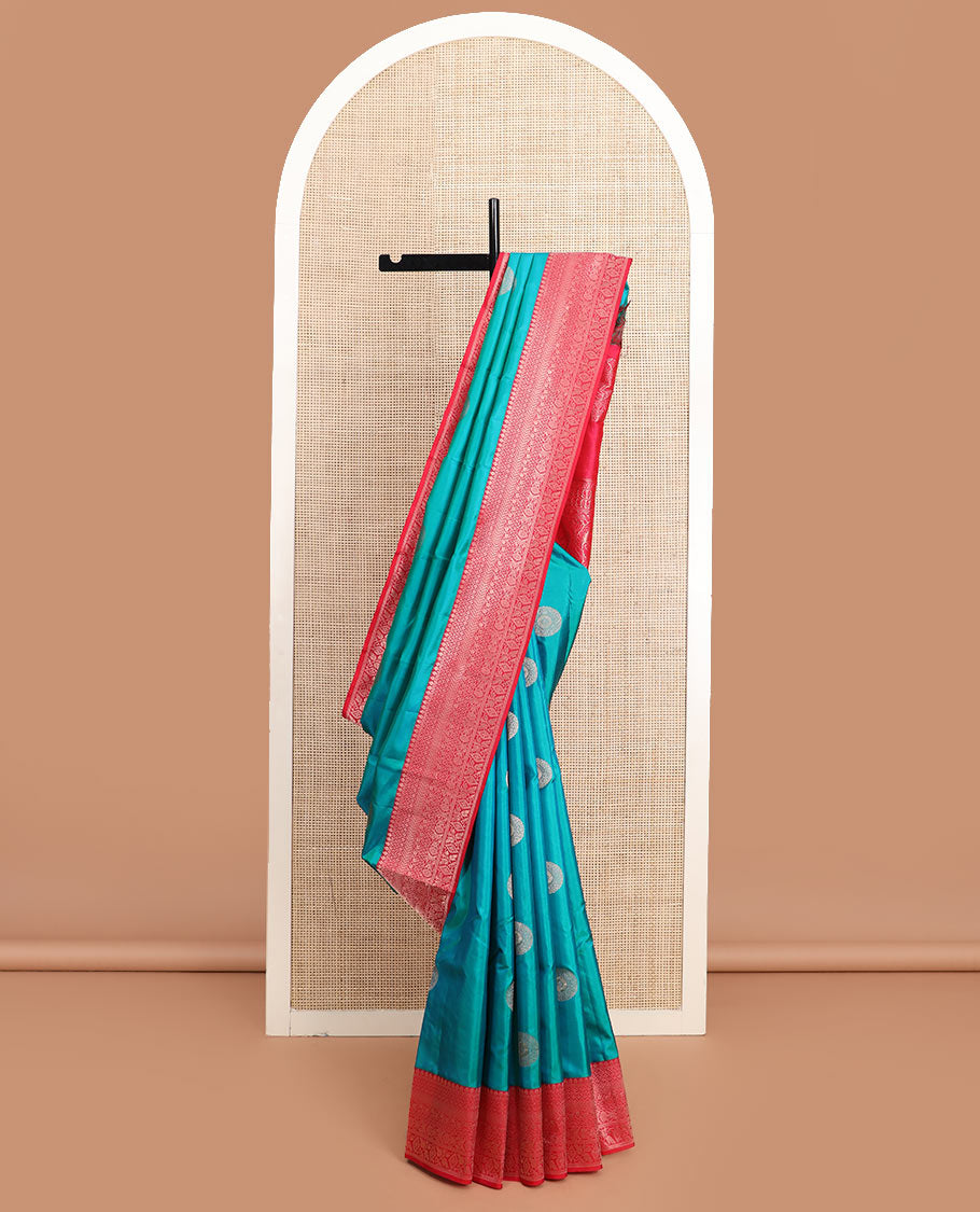 Peacock blue charkam buttas Vasundhara silk saree, contrast border of thilakam mokku, neli, kamalam, kathir, floral, and diamond designs, and Mughal floral woven pallu