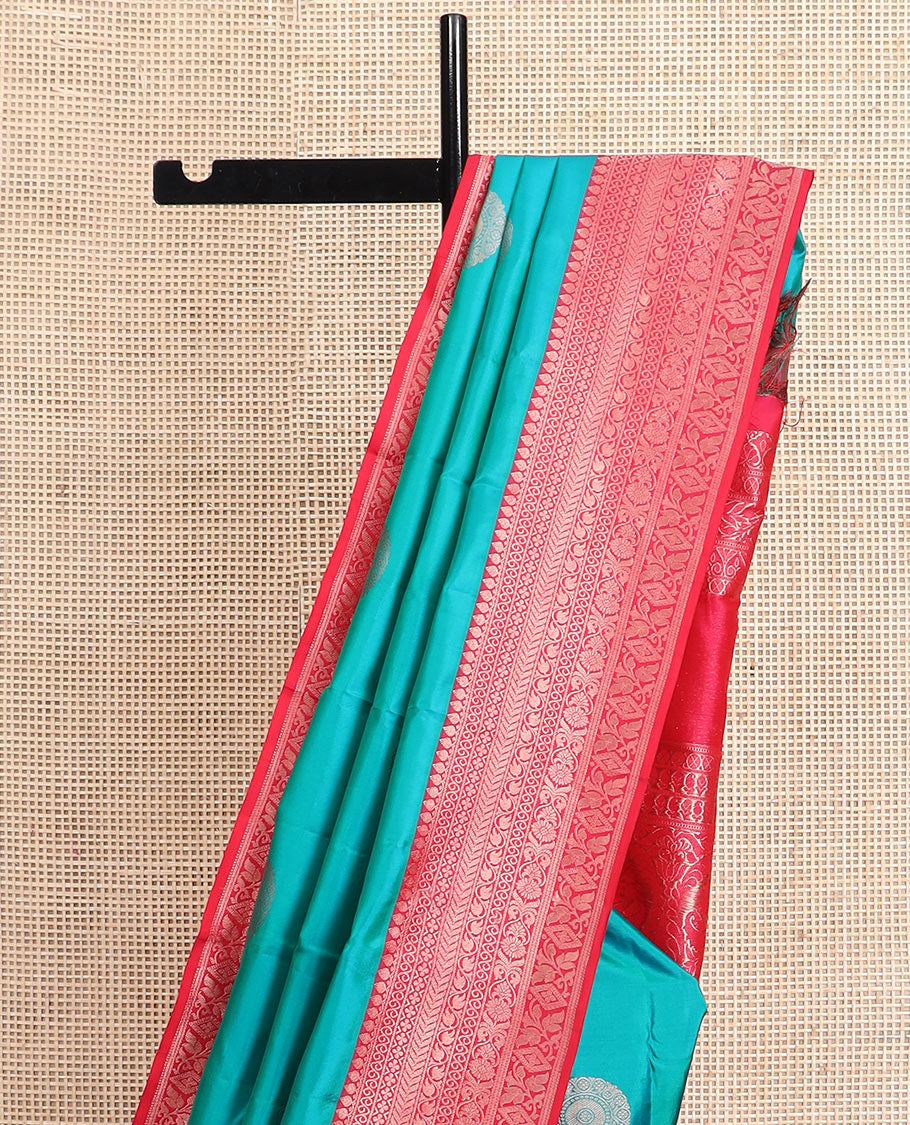 Peacock blue charkam buttas Vasundhara silk saree, contrast border of thilakam mokku, neli, kamalam, kathir, floral, and diamond designs, and Mughal floral woven pallu