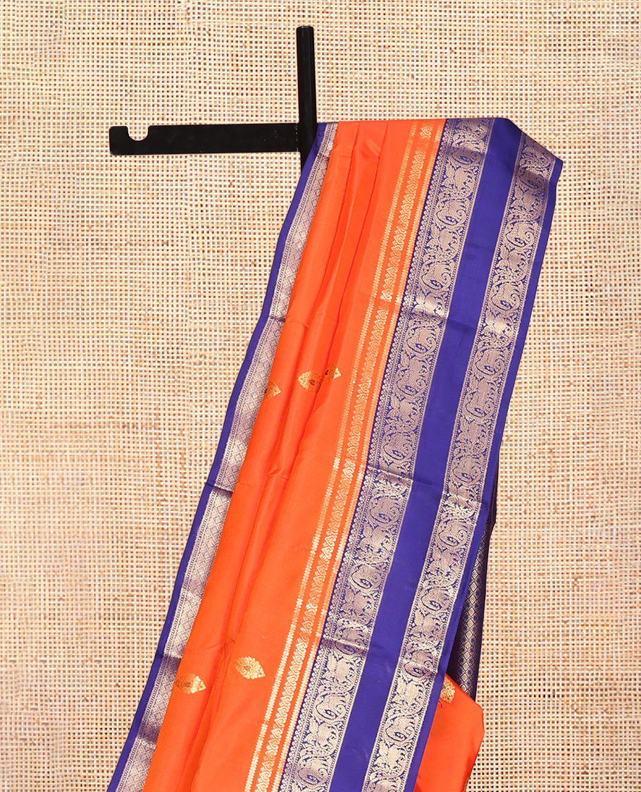 Orange Vasundhara Silk Saree, Adorned with Zari Buttas, Contrast Rettai Pettu Border of Yaanai, and Kuthirai Designs, Grand Pallu, and a Contrast Blouse