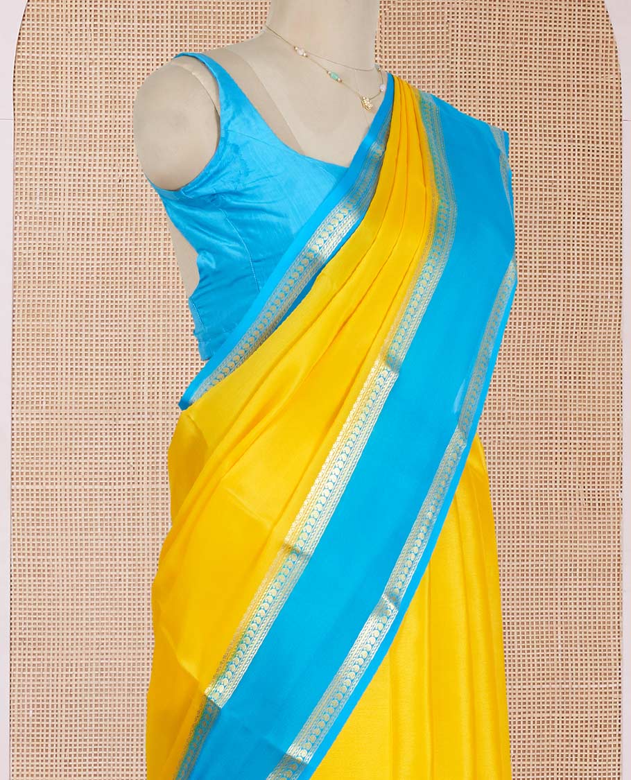Yellow Plain Mysore Silk Saree, Complemented by a Contrast Rettai Pettu Border of Traditional Zari Designs, a Subtly Sparkled Pallu of Zari Stripes, and a Contrast Blouse