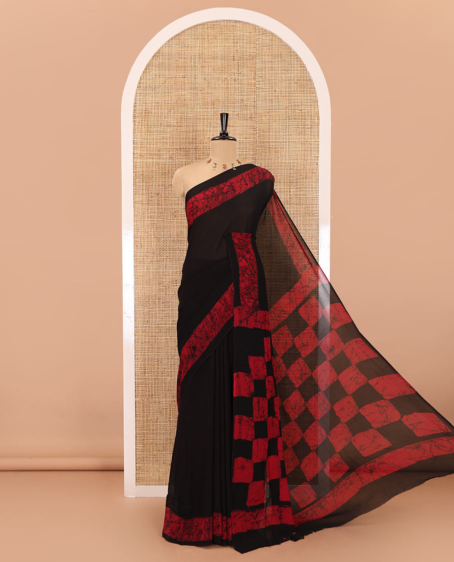Black and rani pink plain georgette saree, batik printed border, batik printed checked pallu, and a matching blouse