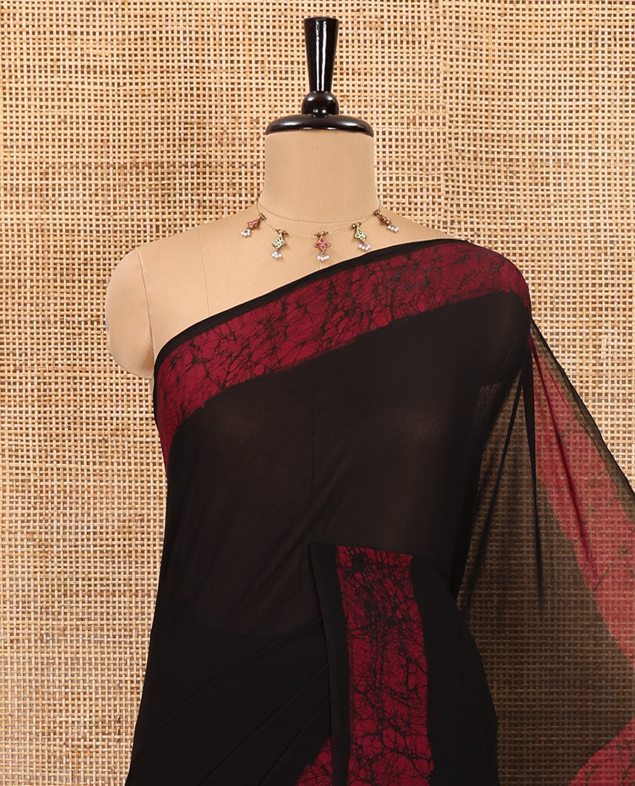 Black and purple plain georgette saree, batik printed border, batik printed checked pallu, and a matching blouse