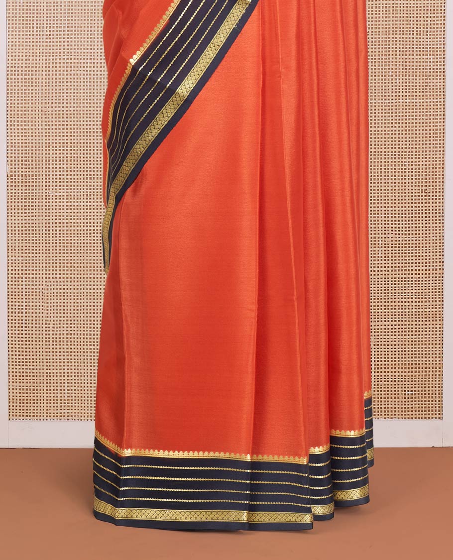 Orange Plain Mysore Silk Saree, Complemented by a Contrast Varisai Pettu Border of Traditional Zari Designs, a Subtly Sparkled Pallu of Zari Stripes, and a Contrast Blouse