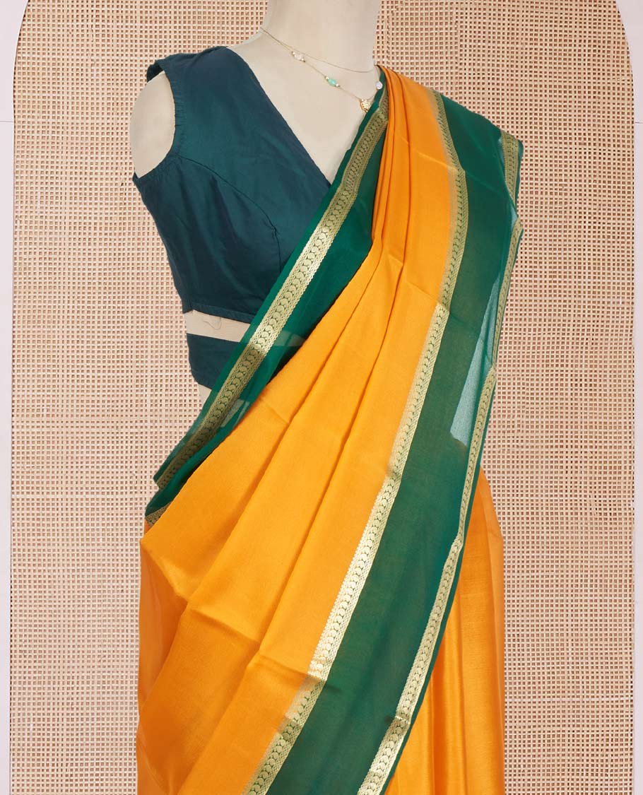 Orange Plain Mysore Silk Saree, Complemented by a Contrast Rettai Pettu Border of Paisley Designs, Pallu Mirrors the Same Border Motifs, and a Contrast Blouse