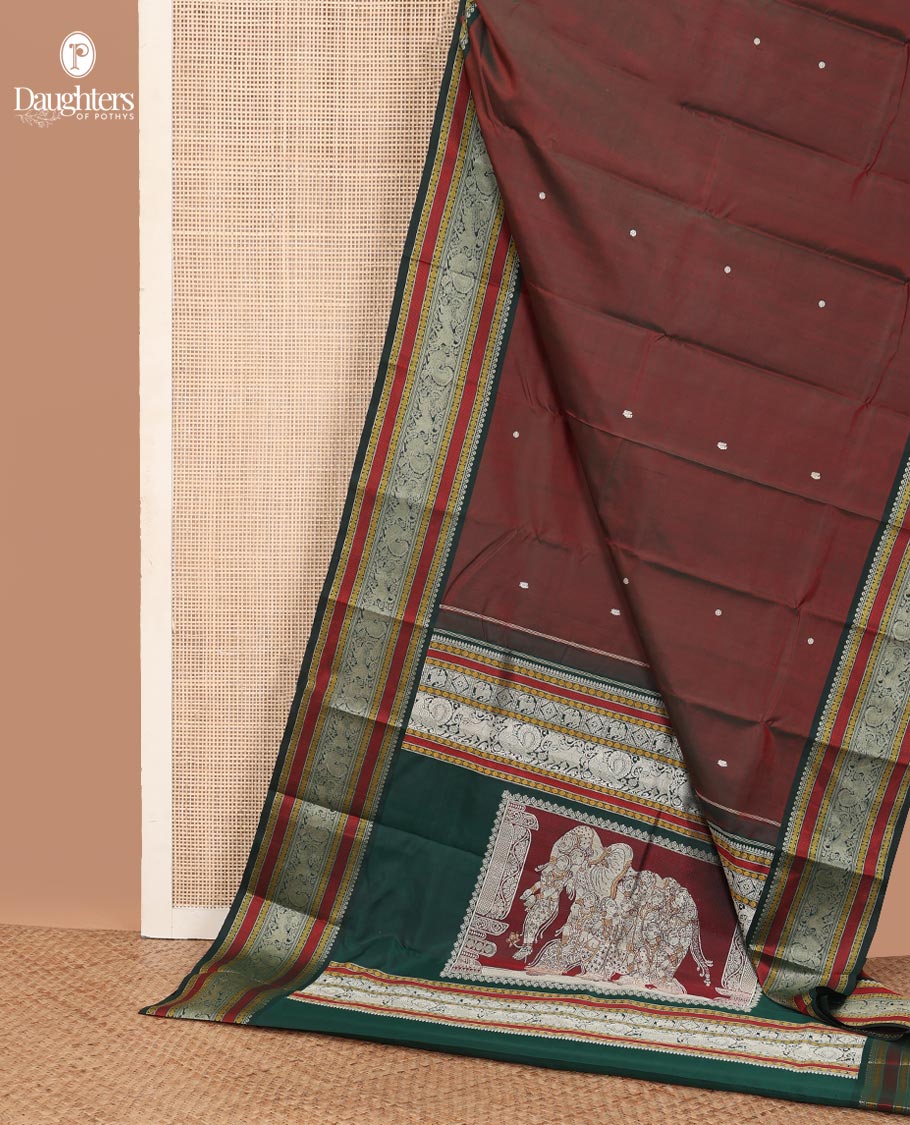 Maroon mayil chakram thread buttas Kanchipuram silk saree, contrast border of thilakam mokku, mayil, yaali, and rudraksham, and pallu of big Nava Nari Kunjara motif