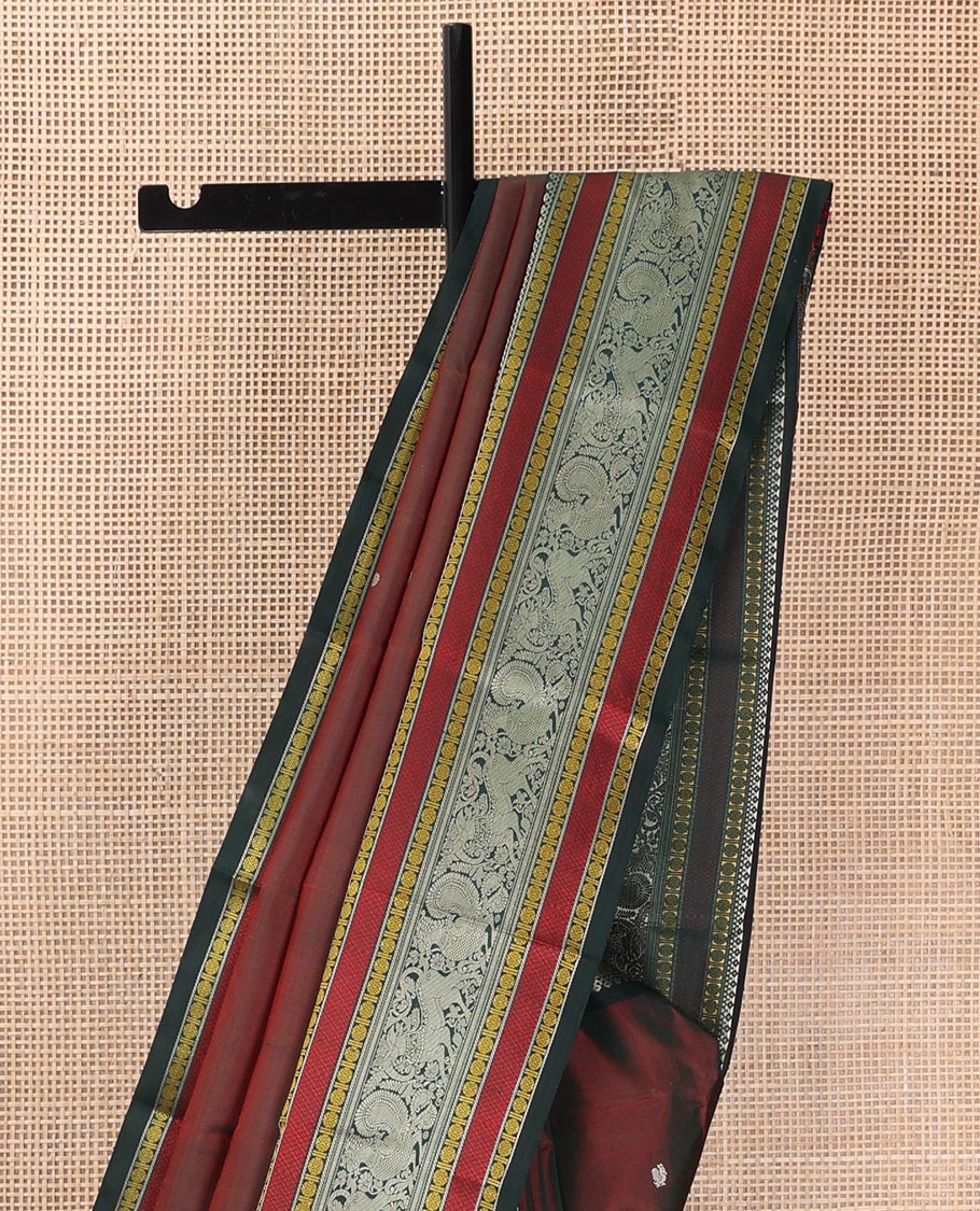 Maroon mayil chakram thread buttas Kanchipuram silk saree, contrast border of thilakam mokku, mayil, yaali, and rudraksham, and pallu of big Nava Nari Kunjara motif
