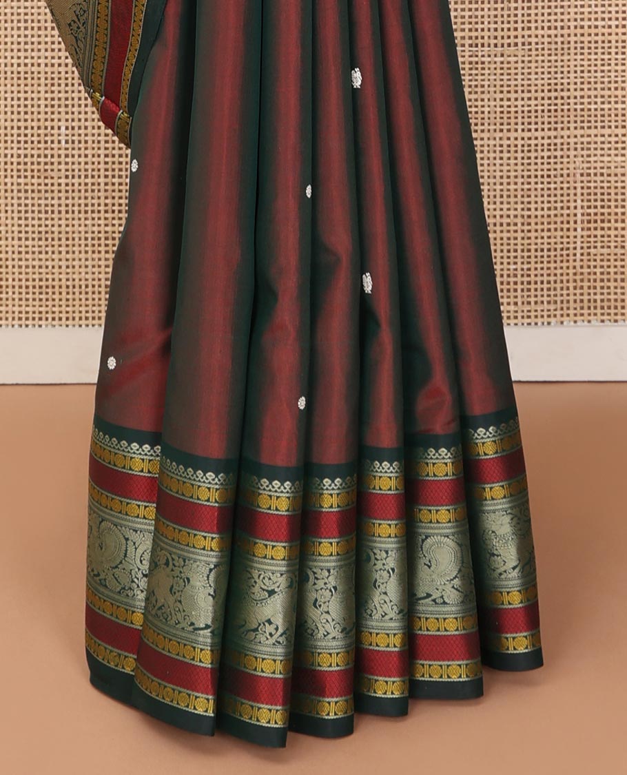 Maroon mayil chakram thread buttas Kanchipuram silk saree, contrast border of thilakam mokku, mayil, yaali, and rudraksham, and pallu of big Nava Nari Kunjara motif