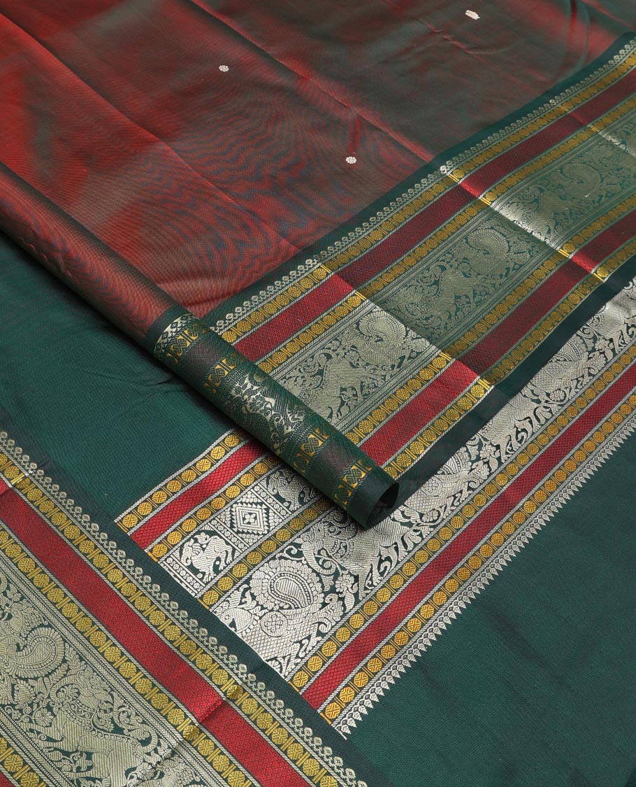 Maroon mayil chakram thread buttas Kanchipuram silk saree, contrast border of thilakam mokku, mayil, yaali, and rudraksham, and pallu of big Nava Nari Kunjara motif