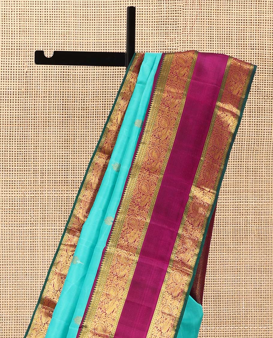 Blue meena buttas Kanchipuram silk saree, contrast korvai border of thilakam mokku, rettai neli, and mayil designs, and geometric patterned pallu
