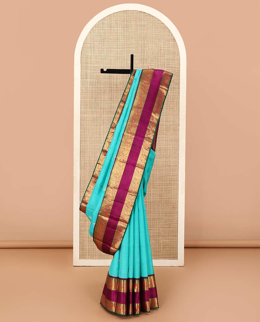 Blue meena buttas Kanchipuram silk saree, contrast korvai border of thilakam mokku, rettai neli, and mayil designs, and geometric patterned pallu