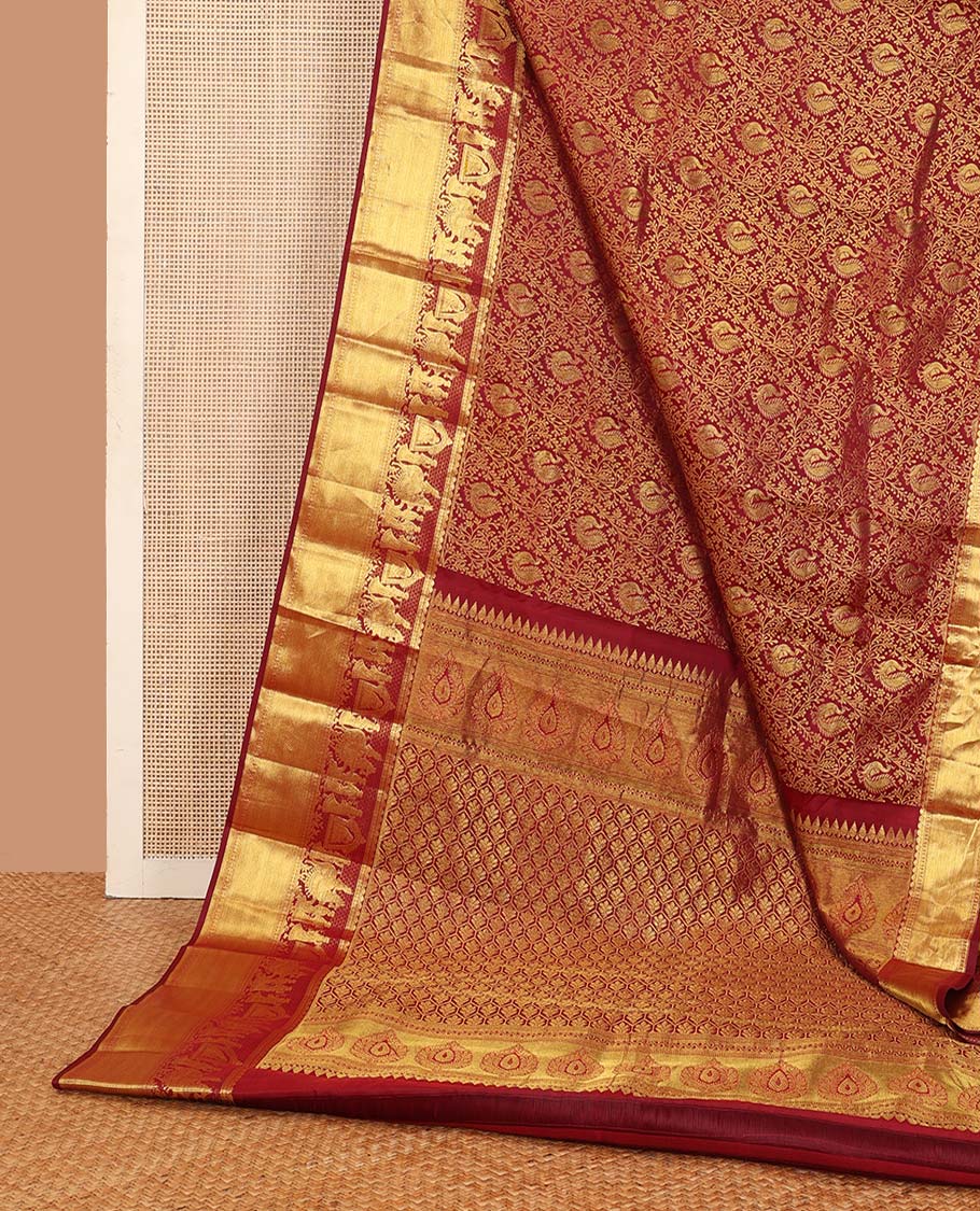 Maroon jacquard wedding silk saree, traditional zari border of wedding palanquin design, and butta enclosed hexogon grid pallu