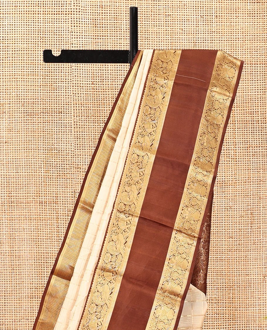 Cream Vasundhara Silk Saree, Enthralled with Zari Buttas Enclosed Checks All Over Its Body, Complemented by a Contrast Rettai Pettu Border of Muthu, Banaras, and Iruthalai Pakshi Designs, a Grand Pallu, and Paired with a Contrast Blouse