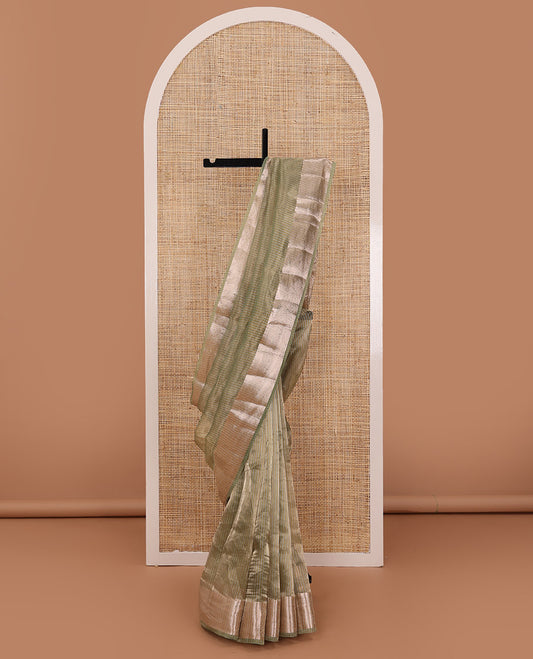 Pastel green sparesely striped tissue saree, Mughal style zari woven border, and intricately zari woven pallu