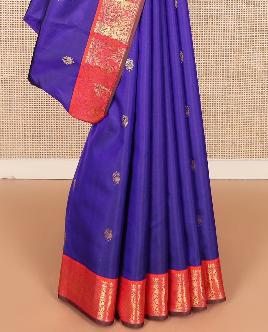 Blue mayil buttas Kanchipuram silk saree, contrast border of thilakam mokku, muthu, and mayil designs, and jaal pallu