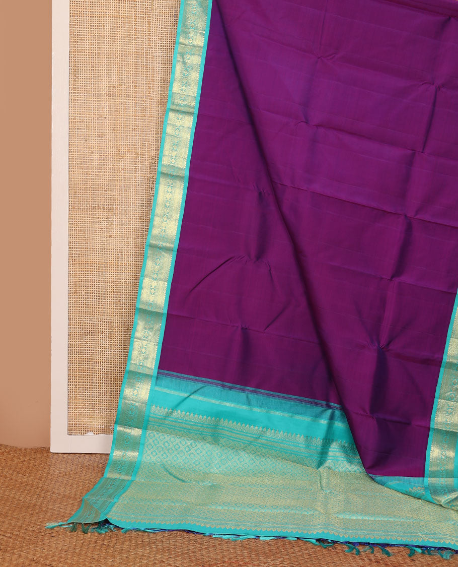 Purple plain Kanchipuram silk saree, contrast korvai border of thilakam mokku, muthu, vanki, lavangam, neli, diamond, and manga designs, and jaal pallu