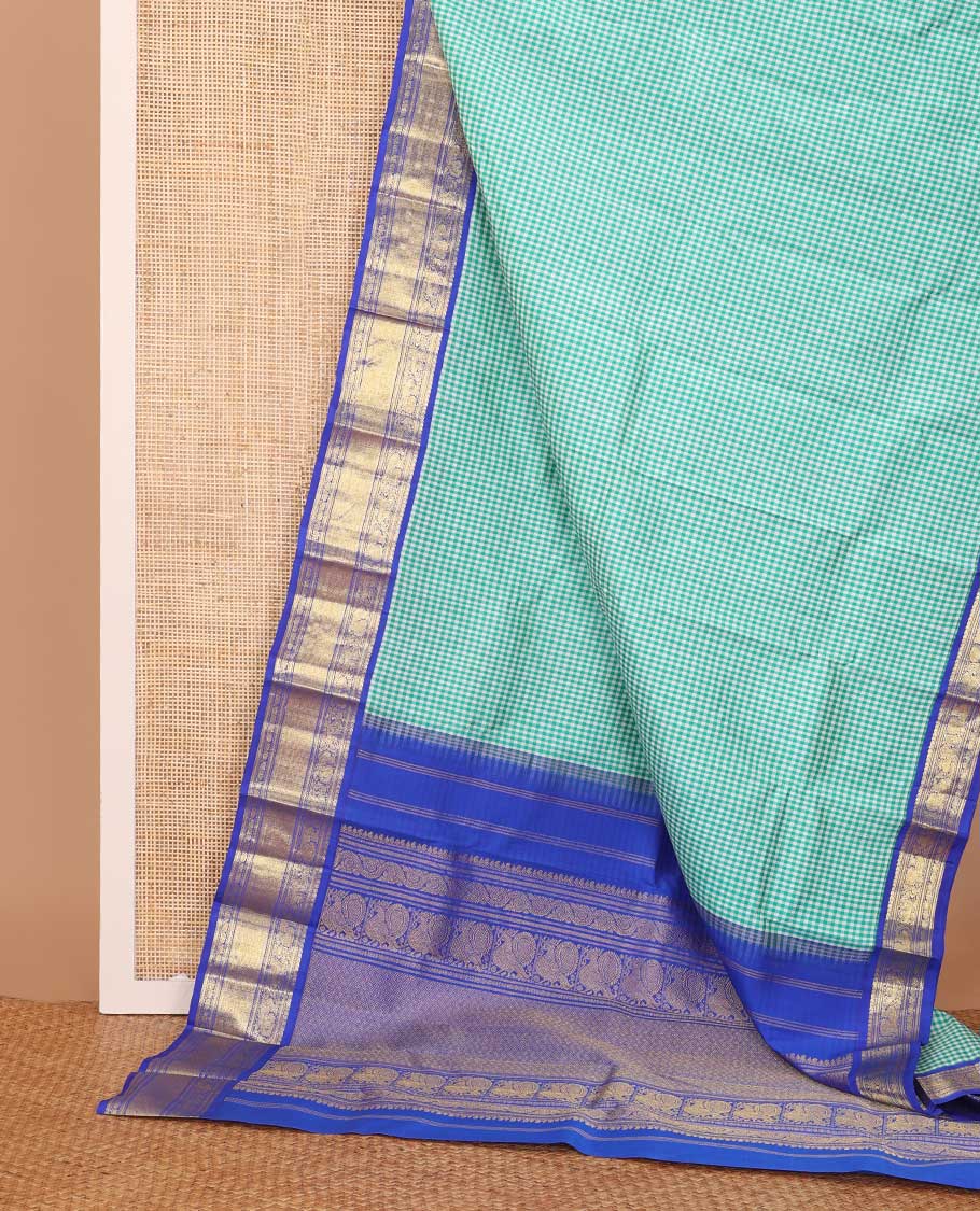 Blue micro-checked Kanchipuram silk saree, contrast korvai border of manga mokku,kathir,muthu,manga and mayil and jaal pallu