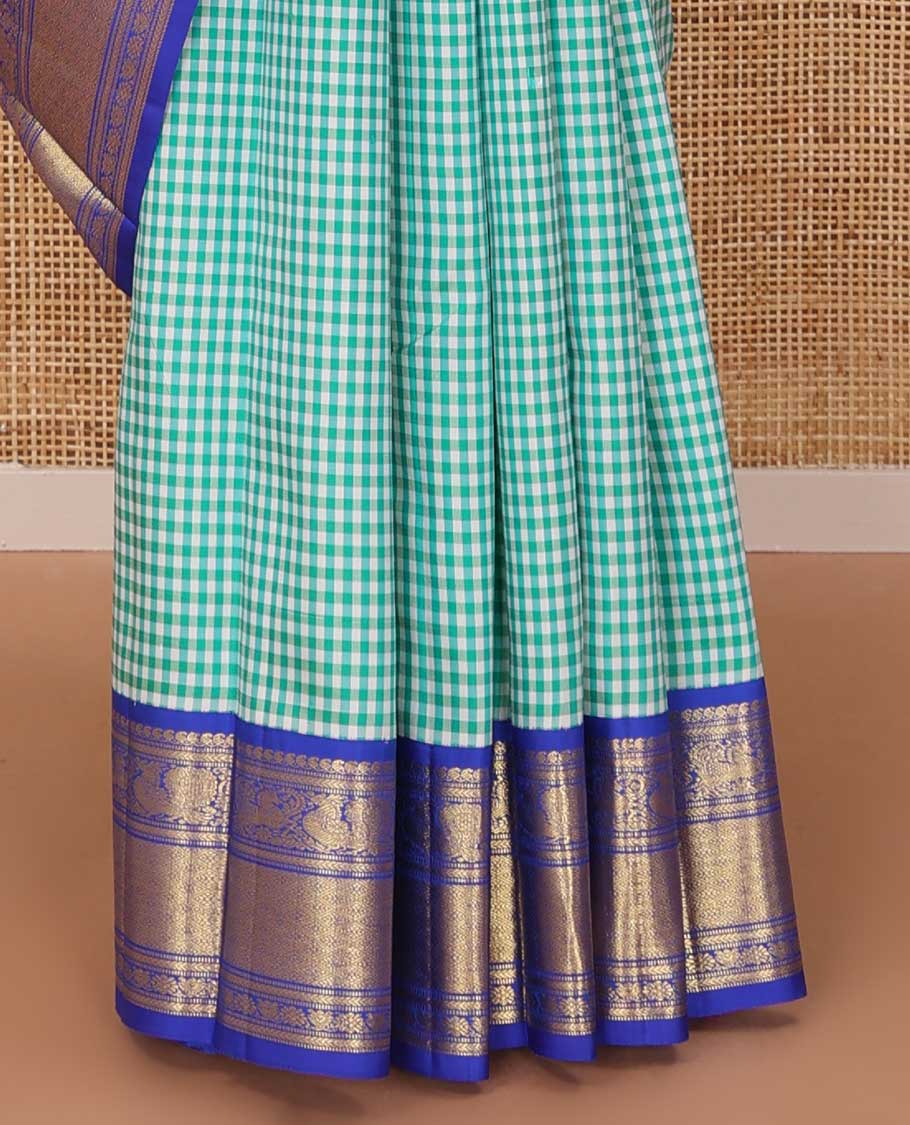 Blue micro-checked Kanchipuram silk saree, contrast korvai border of manga mokku,kathir,muthu,manga and mayil and jaal pallu