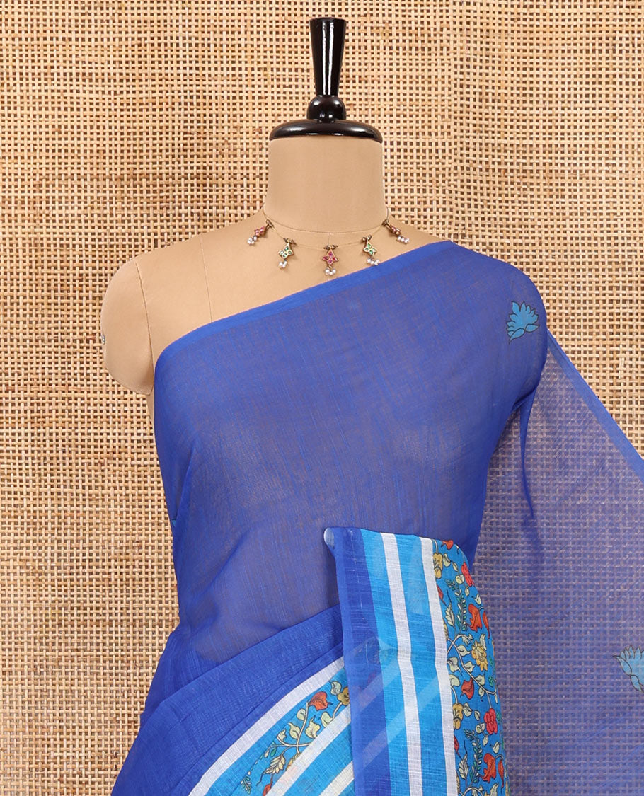 Blue floral motifs printed linen cotton saree with contrast kalamkari floral vine printed border, floral vine printed pallu, and a plain blouse