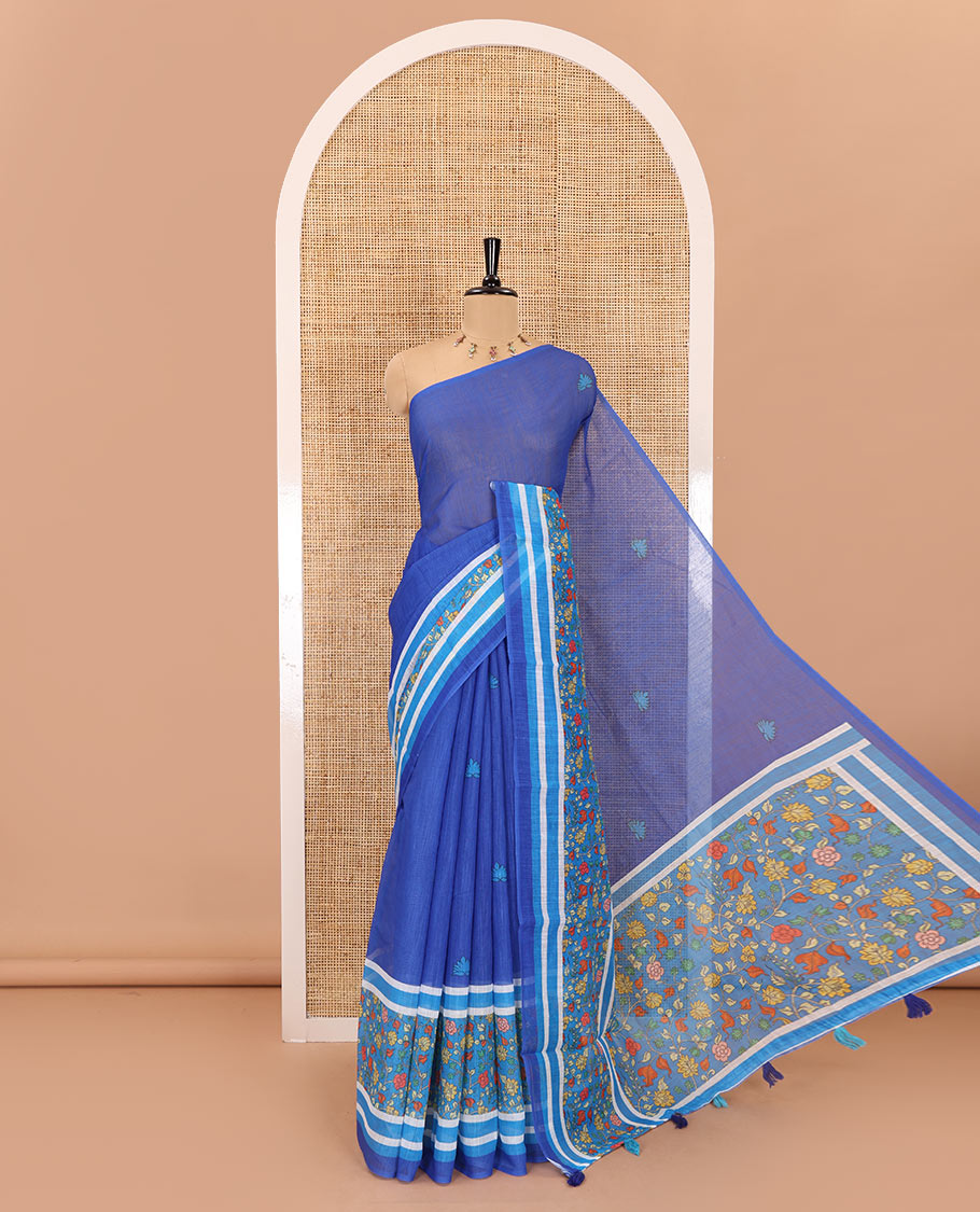 Blue floral motifs printed linen cotton saree with contrast kalamkari floral vine printed border, floral vine printed pallu, and a plain blouse