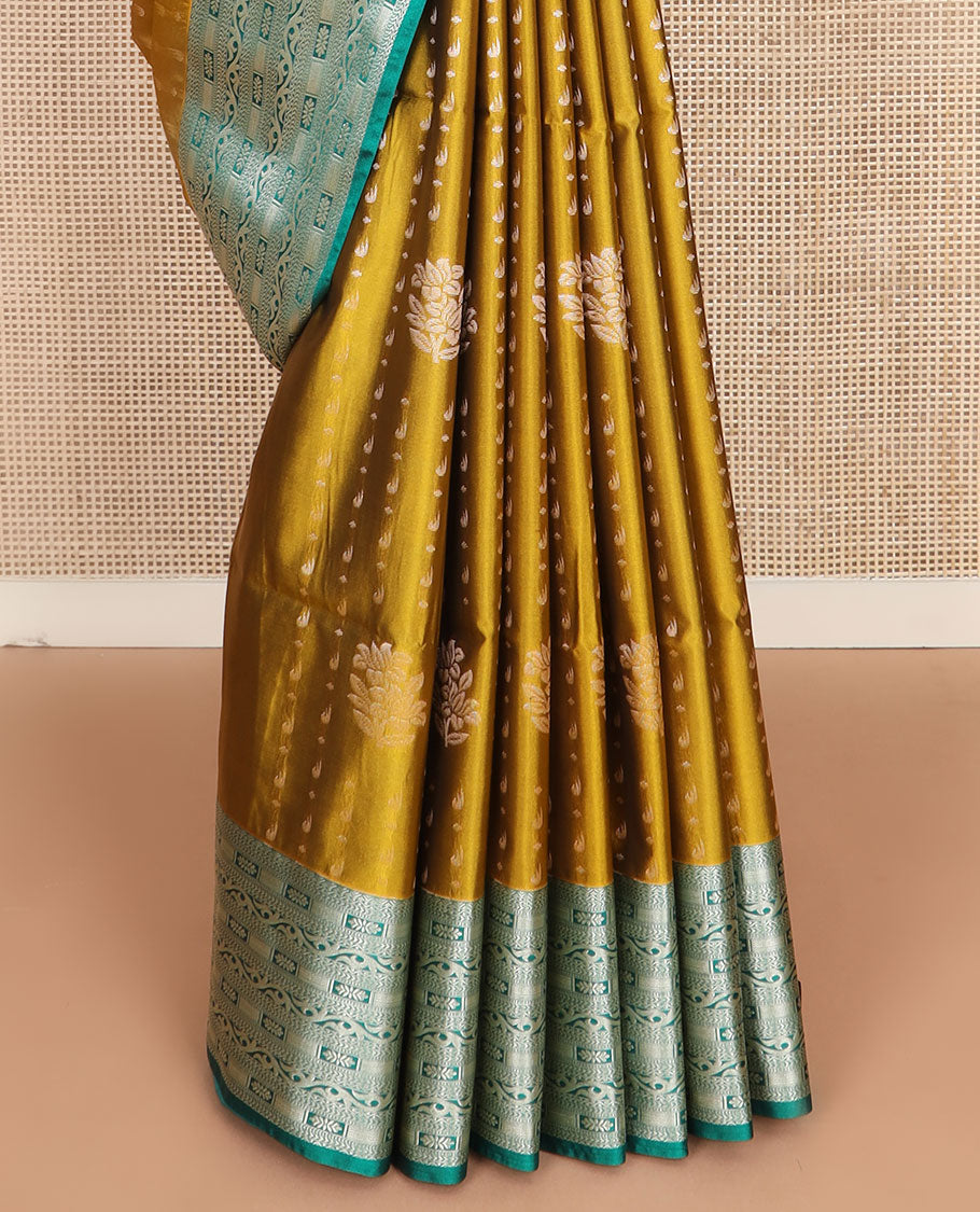 Mustard floral buttas soft silk saree, contrast traditional zari design border, and pallu of geometric patterns
